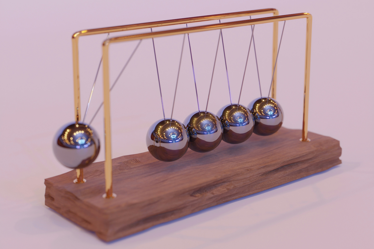 picture of Newton's Cradle with metal ball in motion