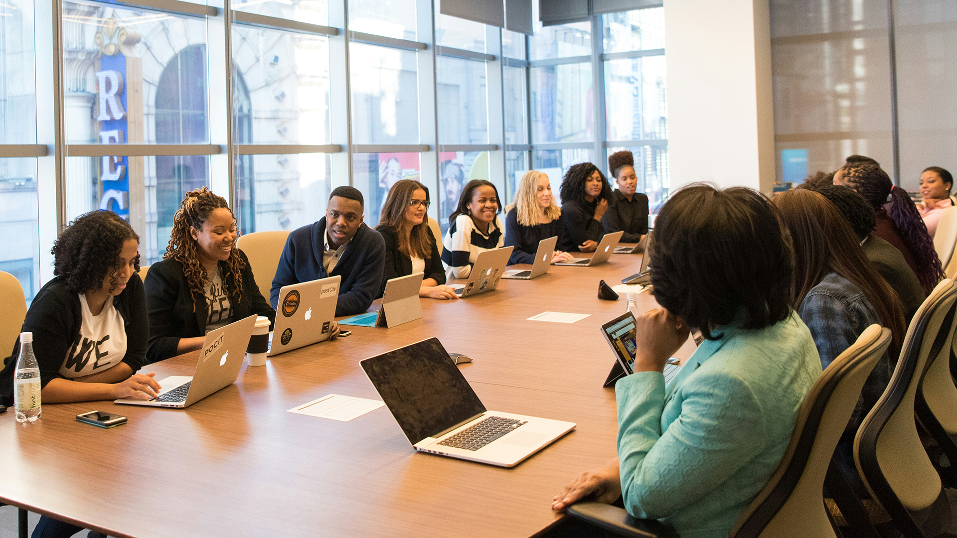 many people gathered around a table for a board meeting